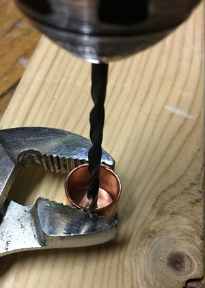 1. Place pipe cap upside down on scrap wood and hold in place with pliers. Use small drill bit to create a pilot hole. Increase bit size and redrill hole until knob bolt fits.