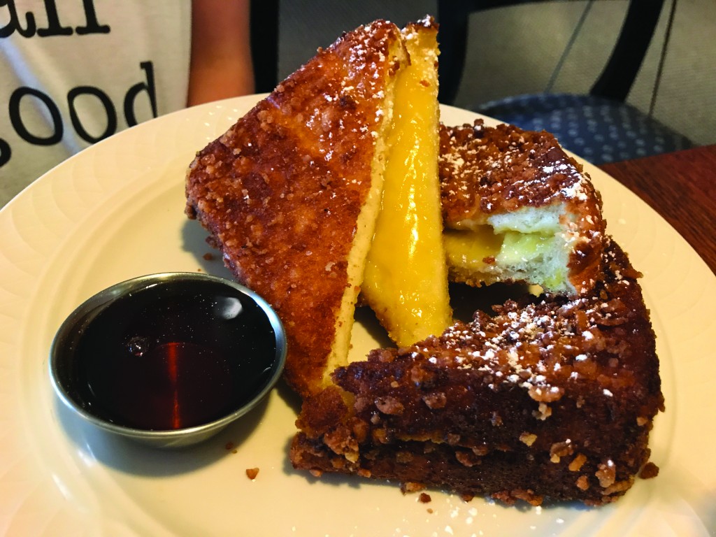 A plate with lemon cheesecake–stuffed French toast and maple syrup for dipping at the Brown Hound Downtown in Rochester NY