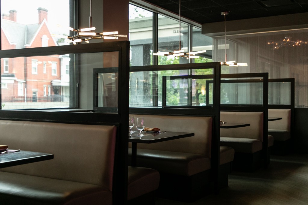 A row of booths by the window at Char Steak and Lounge restaurant in Rochester NY