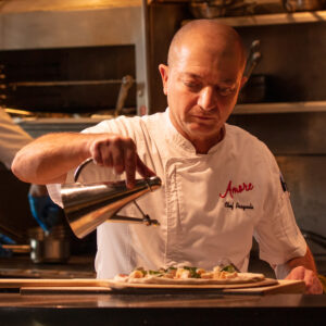 A chef prepares pizza at Amore by Wegmans restaurant in Rochester NY