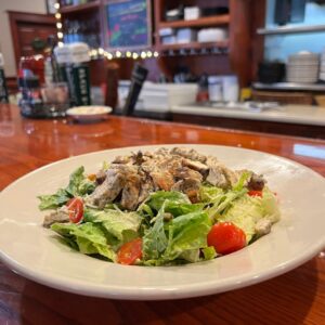 A chicken Caesar salad on the bar counter at McArdle's Restaurant in Fairport NY