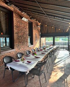 A long table set up for dining on the patio at Pane Vino on the River Italian restaurant in Rochester NY