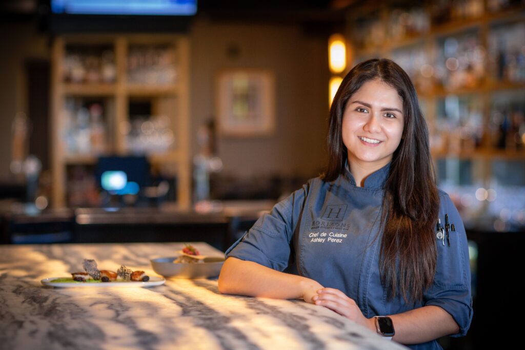 Ashley Perez, chef de cuisine at Woodcliff Hotel and Spa in Rochester NY poses inside Horizons Modern Kitchen and Wine Bar