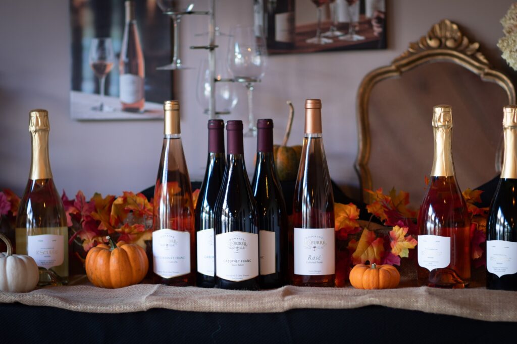 Bottles of wine on a table decorated for autumn at Domaine LeSeurre Winery on the Keuka Wine Trail in the Finger Lakes region of NY