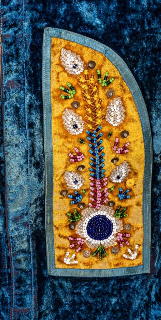 A zoom in of the beaded detail on an Onondaga vest in the Hodinöšyö:nih exhibit at the Rochester Museum of Science in Rochester, NY.