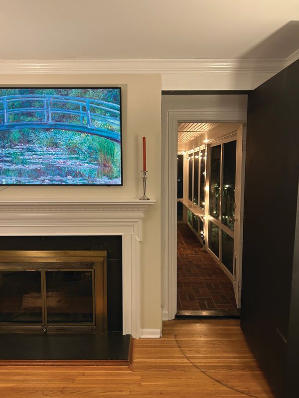 Secret bookshelf that opens into long walkway with lit up floor-to-ceiling windows at night in Rochester, N.Y.