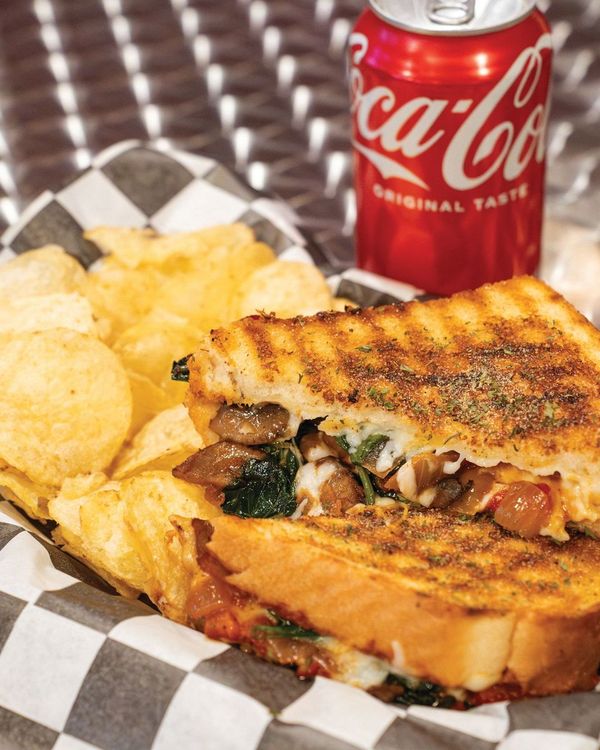 The Veggielicious with fresh spinach, mushrooms, tomatoes, fire roasted red peppers, caramelized onions, and melted mozzarella cheese on Texas toast at The Grilled Cheese Factory ROC in Rochester, N.Y.