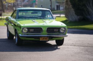 Roní McHugh's 1968 lime green Plymouth Barracuda parked in a driveway in Rochester, N.Y.