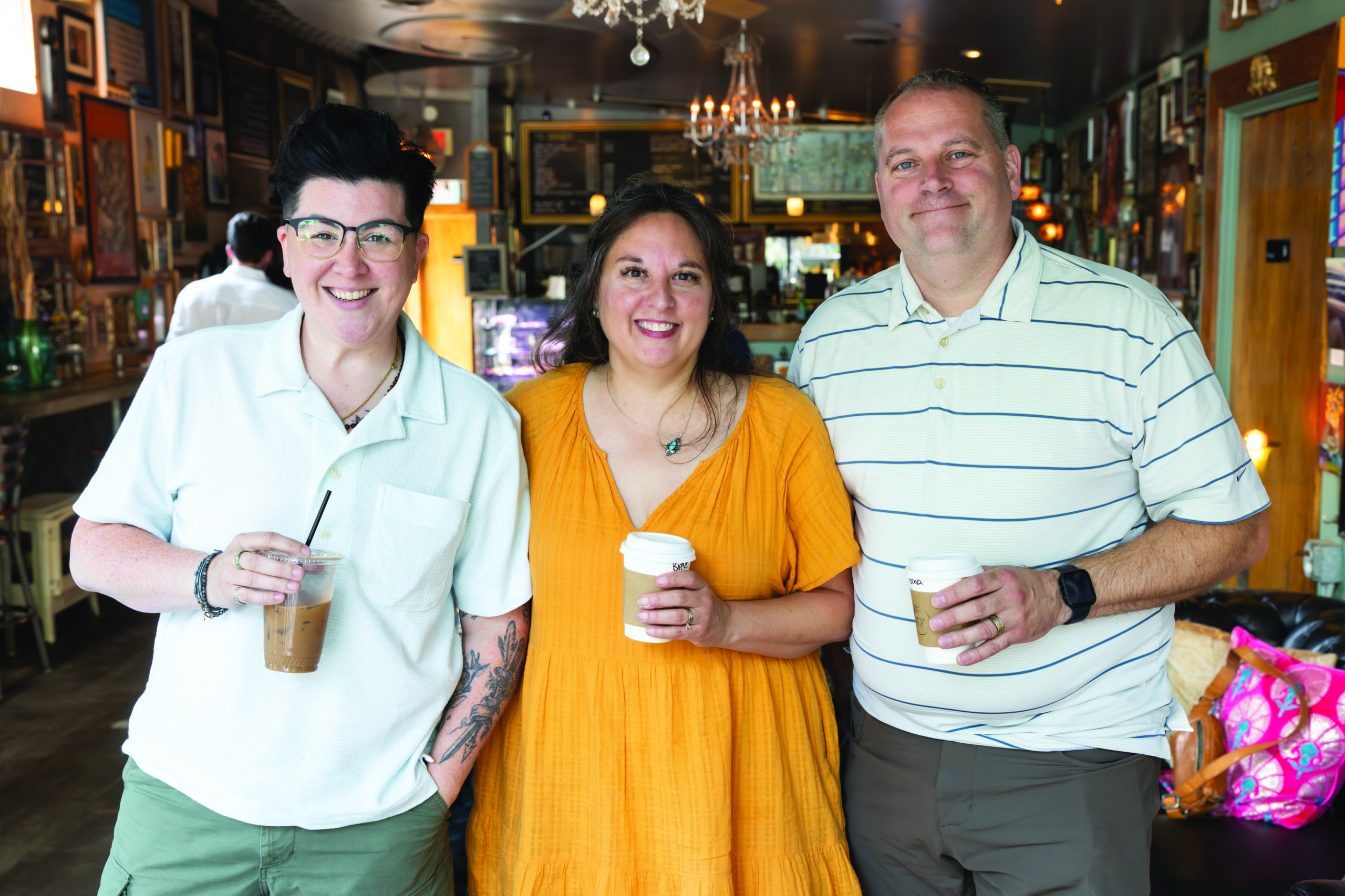 V Spehar, Christine Green, and Nick Koziol posing with coffees in hand at Cafe Sasso on Park Avenue in Rochester, N.Y.