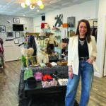 Sarah Pavia, owner of Second Look Boutique, posing in the middle of her store in Rochester, N.Y.